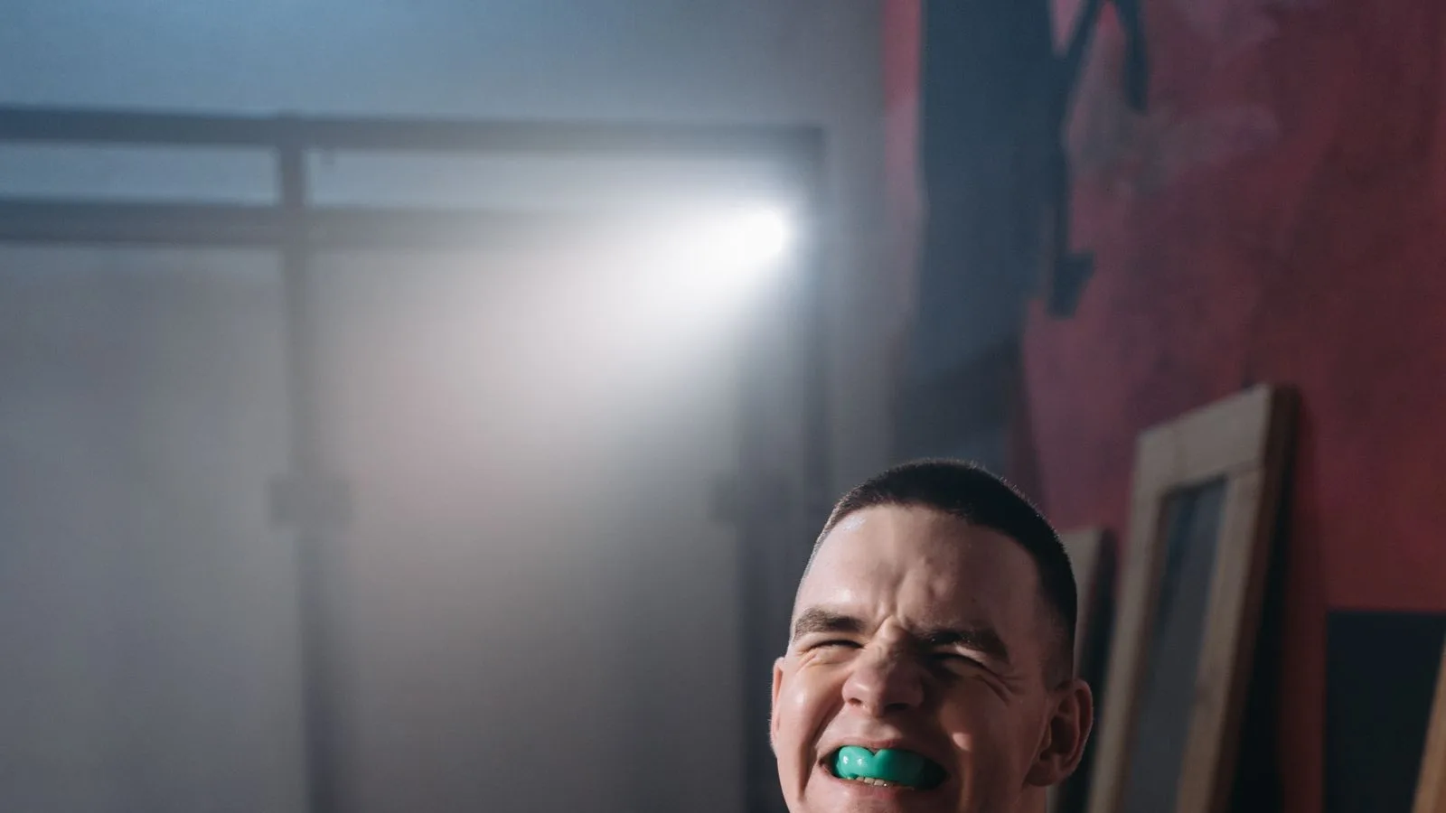 Athlete wearing a green sports mouthguard during training